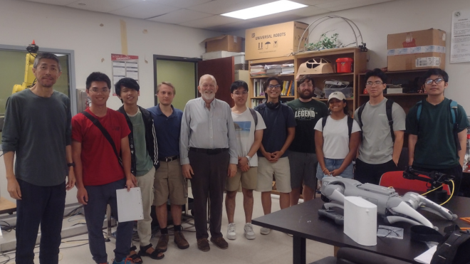 Dr. Sun and Dr. Kearn standing with students from the Hackathon team.
