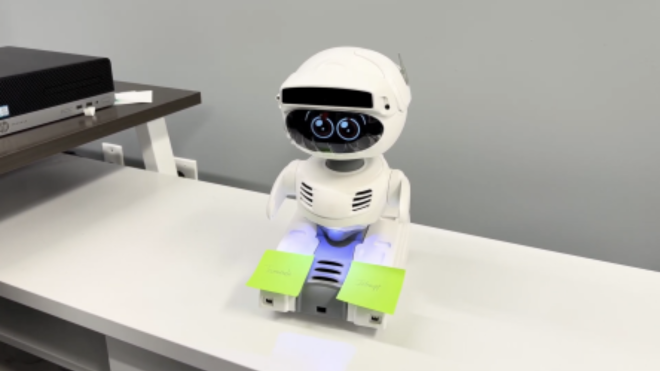 Robot on a desk with sticky notes in front of the robot