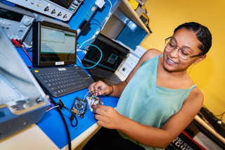 Deziree Price, an intern at the USF Institute of Applied Engineering, works on a Basic Internet of Things Starter Kit (BISKit).