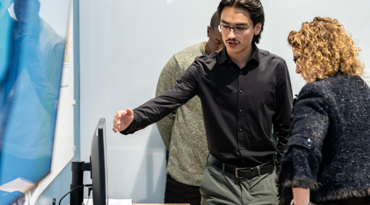 Intern pointing at computer