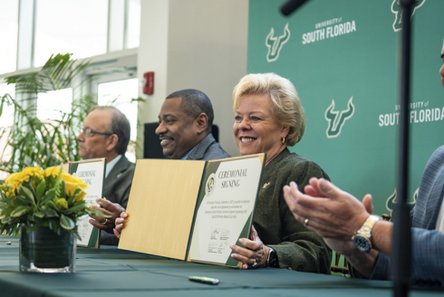 University of South Florida President Rhea Law holds the university's $85 million contract with the US Army at a signing ceremony on Sept. 4.