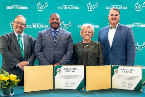 USF posing with US Army at a signing ceremony.