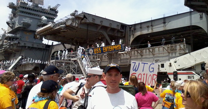 Chad Drummond standing in front of the USS Enterprise