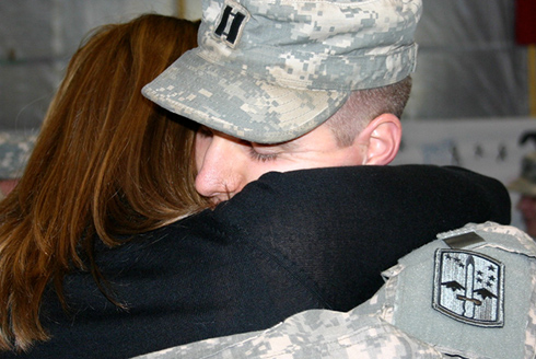 Samantha Tromly, program director of the USF Institute of Applied Engineering, embraces her husband, Maj. Kevin Tromly, following his return from deployment to Iraq