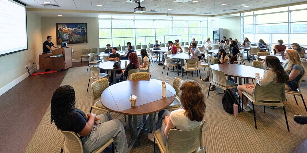 High school students sit and watch a lecture
