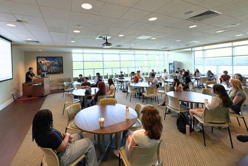 High school students sit and watch a lecture
