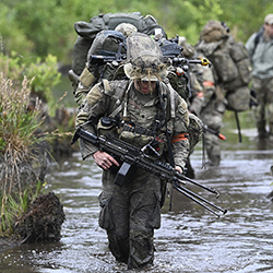 Special Forces assigned to U.S. Army Train on a Water Obstacle Course