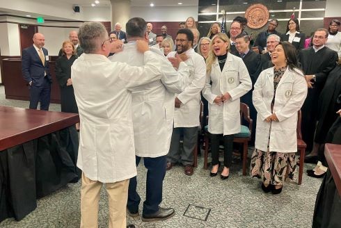 Judges receiving symbolic medical white coats