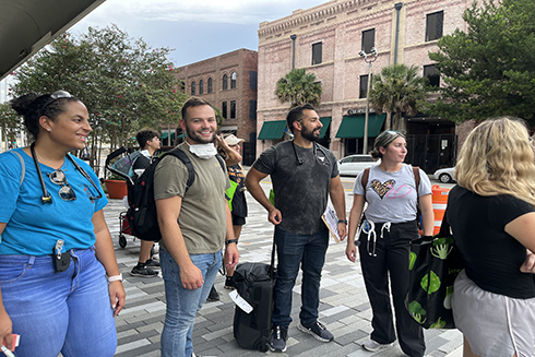 Members of the global health team outside with bags and luggage