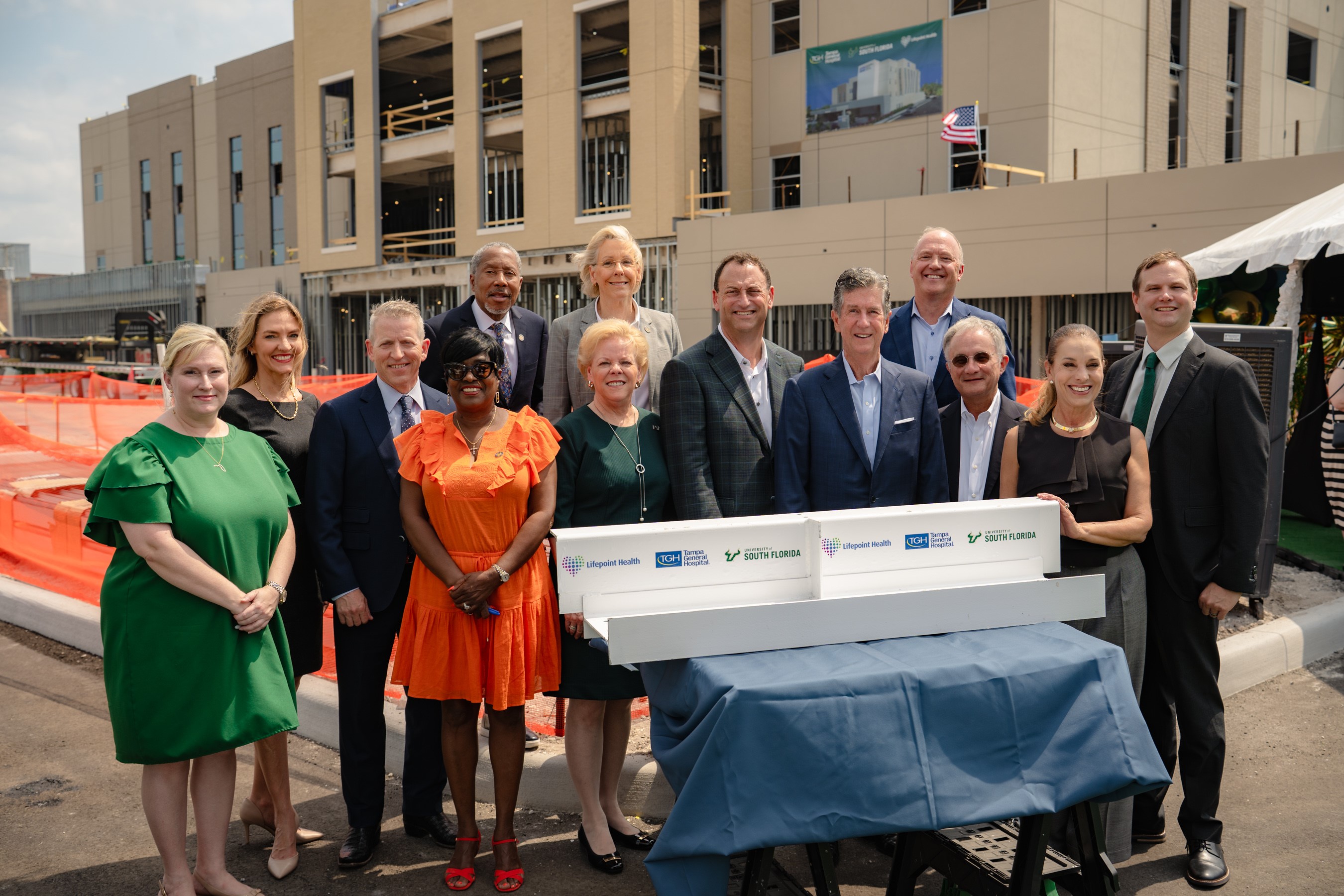 Leadership sign the beam at topping off celebration.