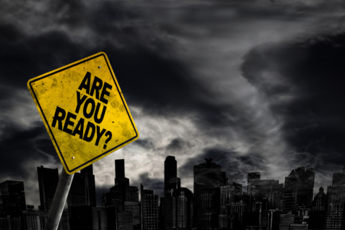 Are You Ready warning sign against a powerful stormy background with city silhouette.