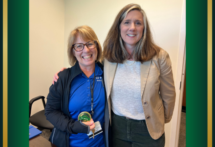 Patti Lane and Renée Dubault posing together with culture coin.