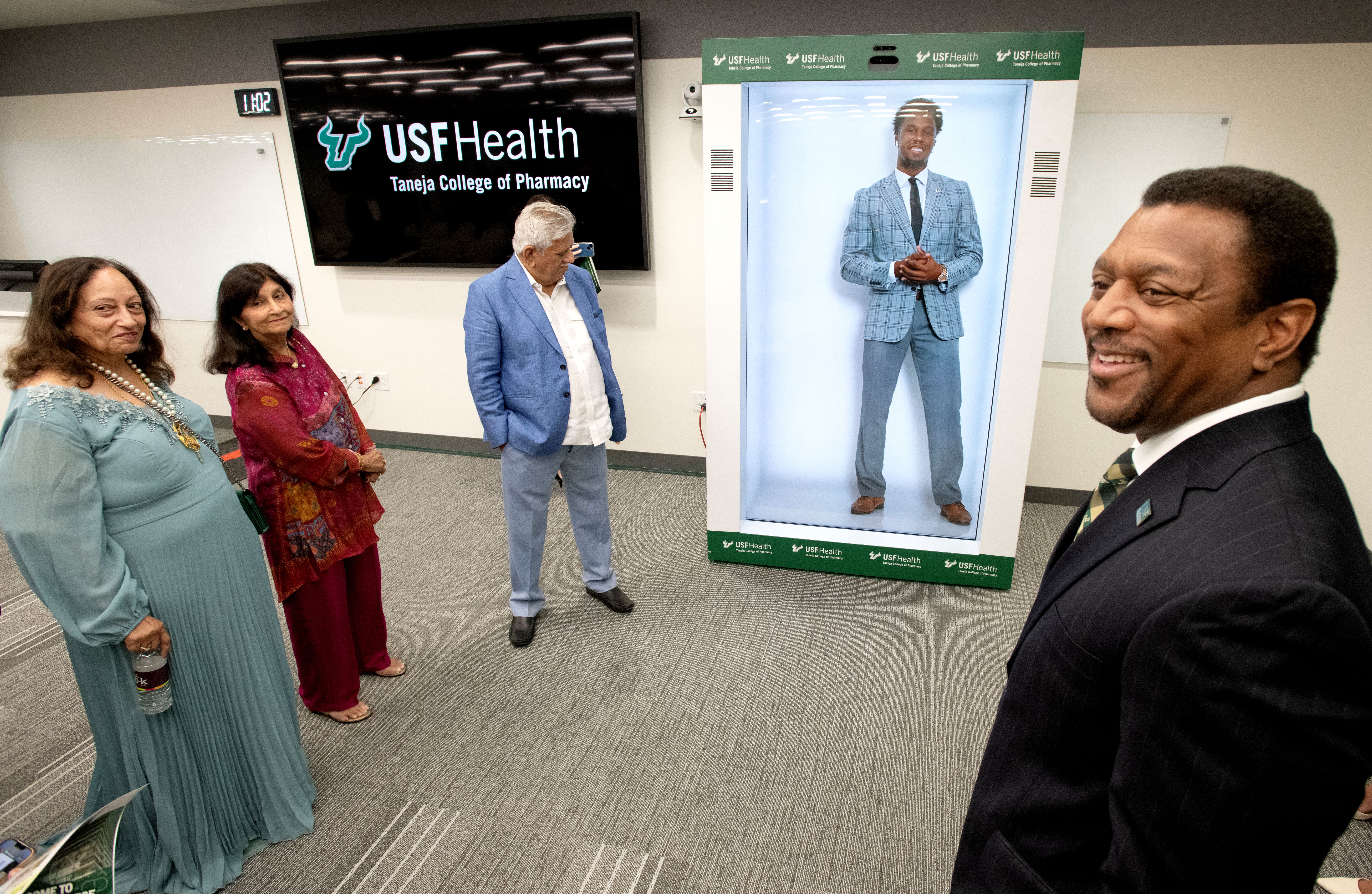 Dr. Sneed demonstrates the new holographic technology.