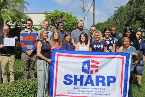 Tintometer employees gather to receive the SHARP award, underscoring the company’s dedication to workplace safety.