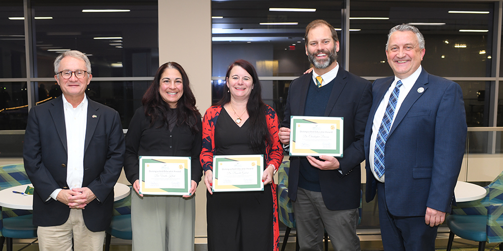 Vinita Kiluk, MD, Danielle Gulick, PhD and Christopher DuCoin, MD, MPH (center), with Charles J. Lockwood, MD, MHCM, executive vice president of USF Health and dean of the USF Health Morsani College of Medicine (left), and Bryan Bognar, MD, MPH, vice dean of educational affairs at the Morsani College of Medicine, at the Academy of Distinguished Educators awards ceremony Jan. 22. 