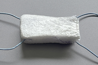 Medical implant with woven biopolymer fibers and pre-attached sutures designed to repair torn ligaments and tendons