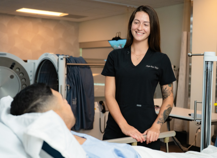 Kayla Steen aside an hyperbaric oxygen chamber