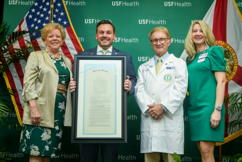 President Law, Representative Anderson, and Dr. Lockwood holding a signed copy of the Sunshine Genetics Act. 