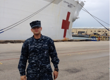 Velasquez in front of the U.S. Naval Hospital Ship MERCY