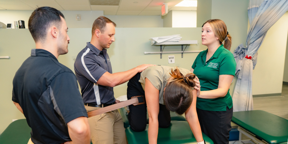Mackenzie Brittain, PT, DPT, OCS, works with residents during a hands-on training s