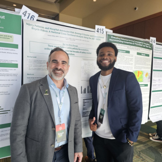 Dr. Salemi and a student in front of research posters