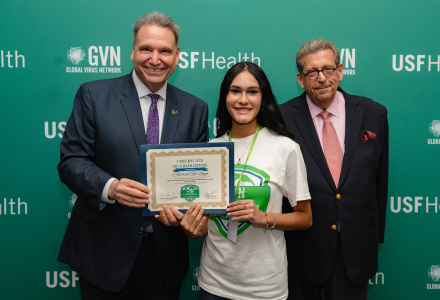 President Moez and Matt Evins presnting a certificate to a student