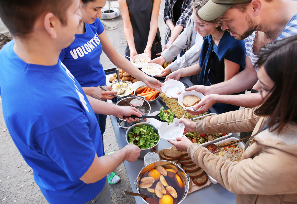 Volunteers distribute food to community members following a natural disaster.