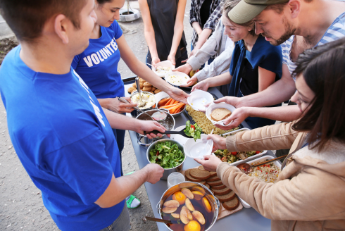 Volunteers distribute food to community members following a natural disaster.