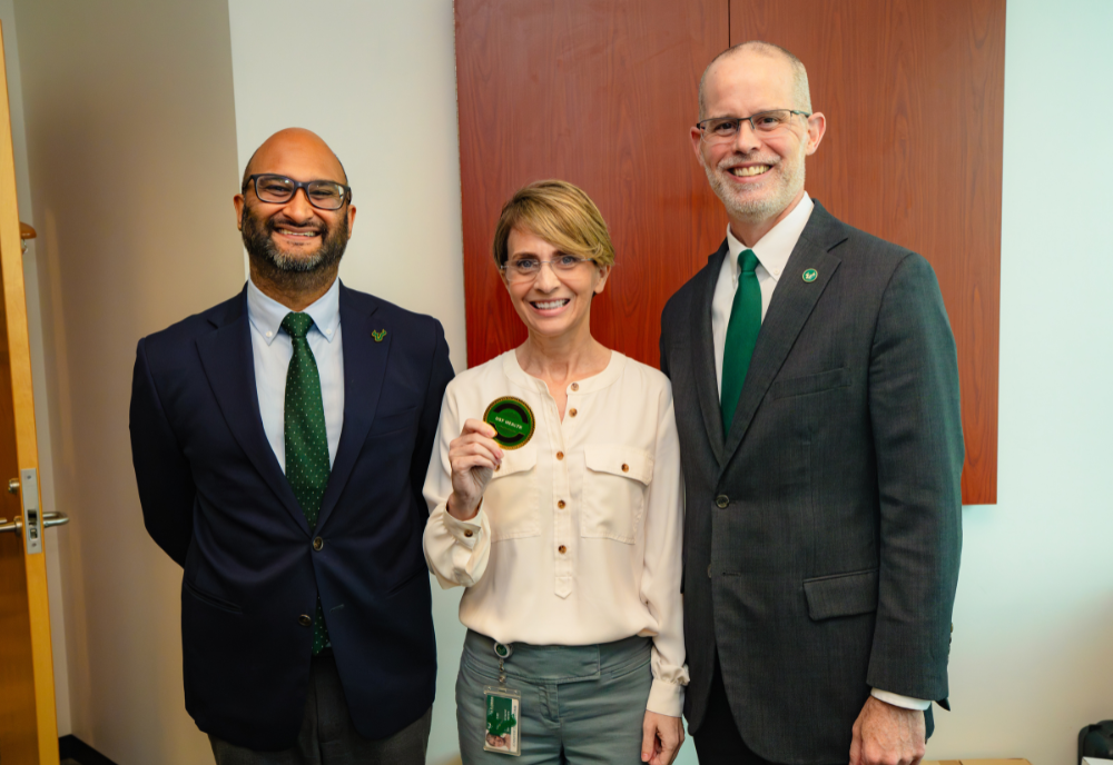 Jennifer Newcomb holding a culture coin.