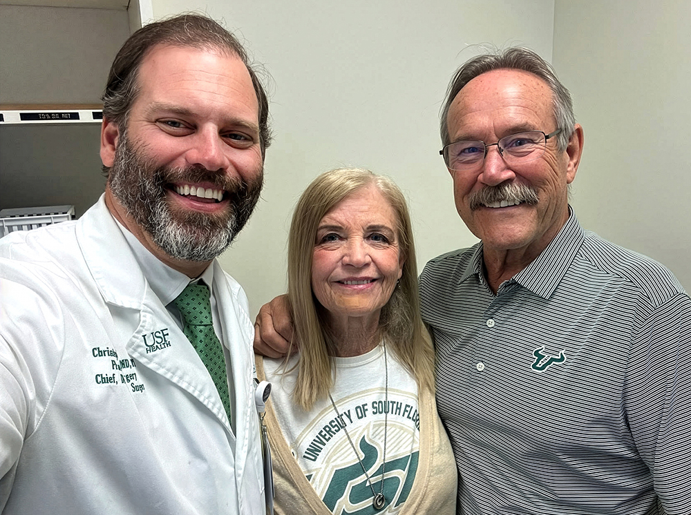 Three people take a selfie in an exam room.