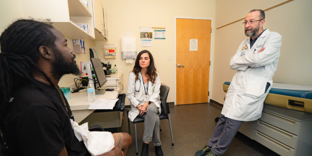 Dr. Doumit and Dr. Pejcic speaking with a patient