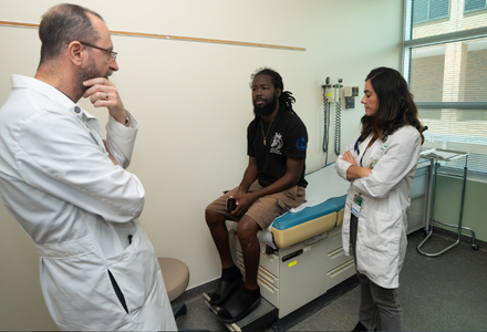 Dr. Doumit and Dr. Pejcic speaking with patient.