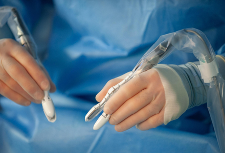 A surgeon operates robotic-assisted instruments designed to improve accuracy and control during complex surgical procedures.