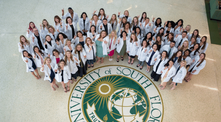 Class of Fall 2023 poses for photo by the USF Seal.