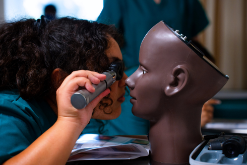 Student examines an eye.