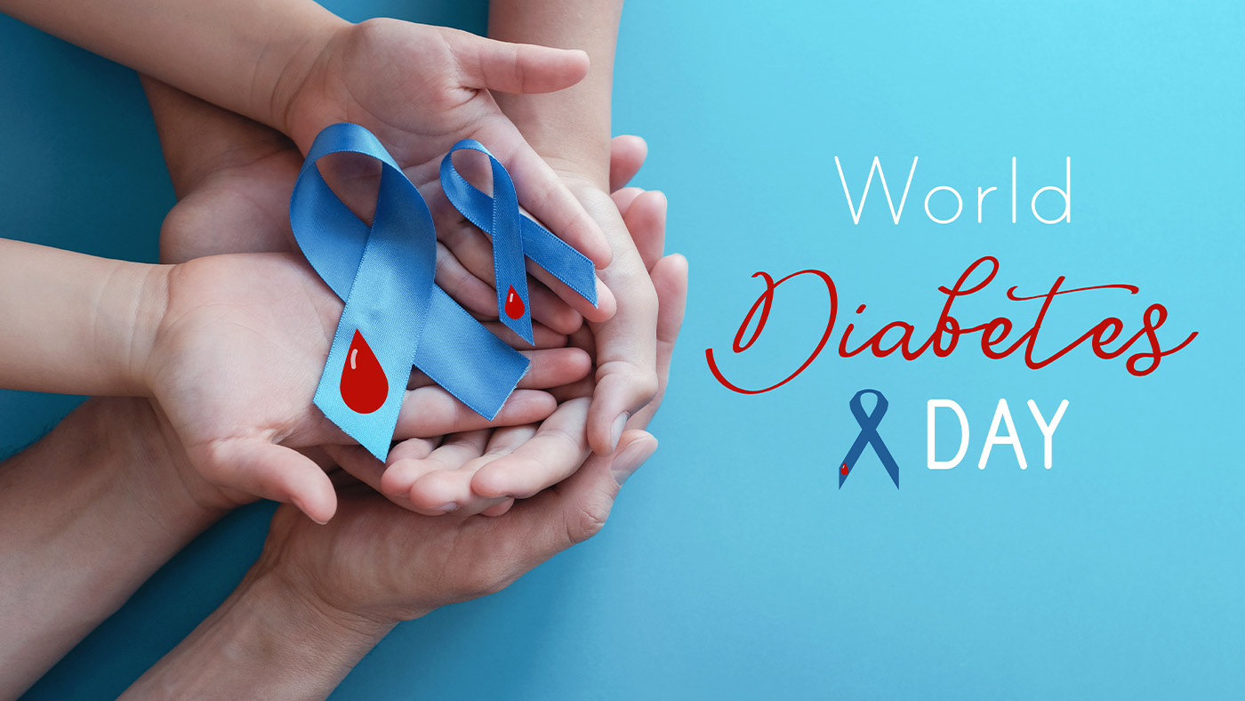 Hands holding blue ribbons on blue background , World Diabetes Day