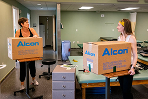 Two people holding boxes