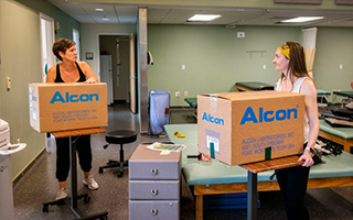 two people holding boxes