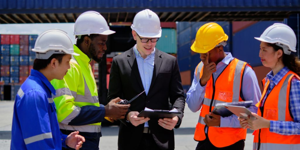 A group of workers gather to discuss plans.