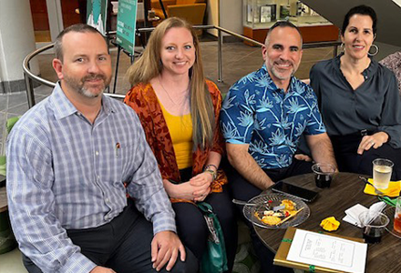 Four people smiling for the camera