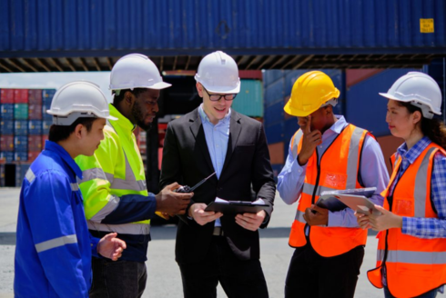 A group of workers gather to discuss plans.