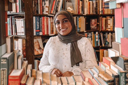 a headshot of a woman with books