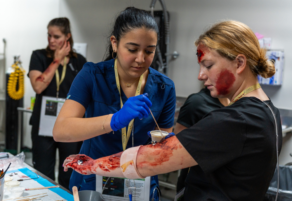 Woman applying fake blood to an actress.