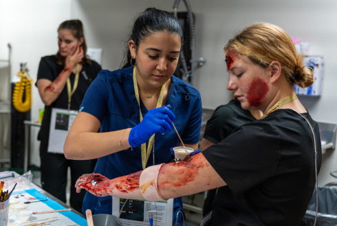 woman applying fake blood to actress