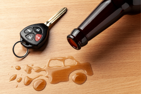 car keys and beer bottle on table with spilled beer dripped in image of car