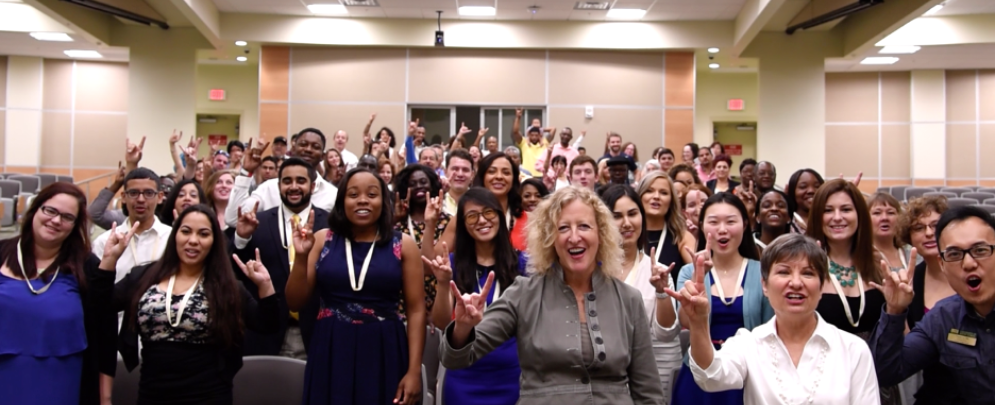 dean petersen with students in auditorium at graduation