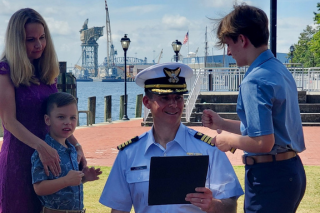 military man being recognized by wife and kids