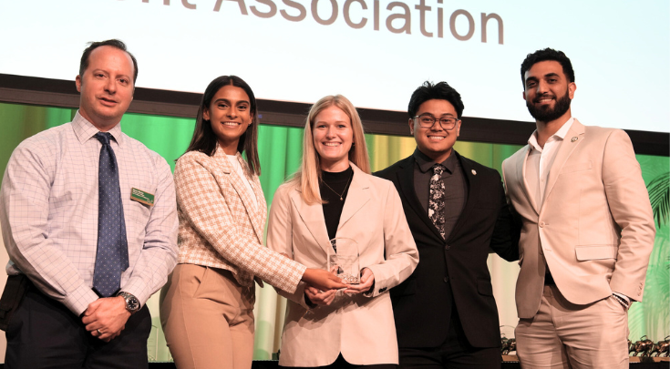 group of students holding an award