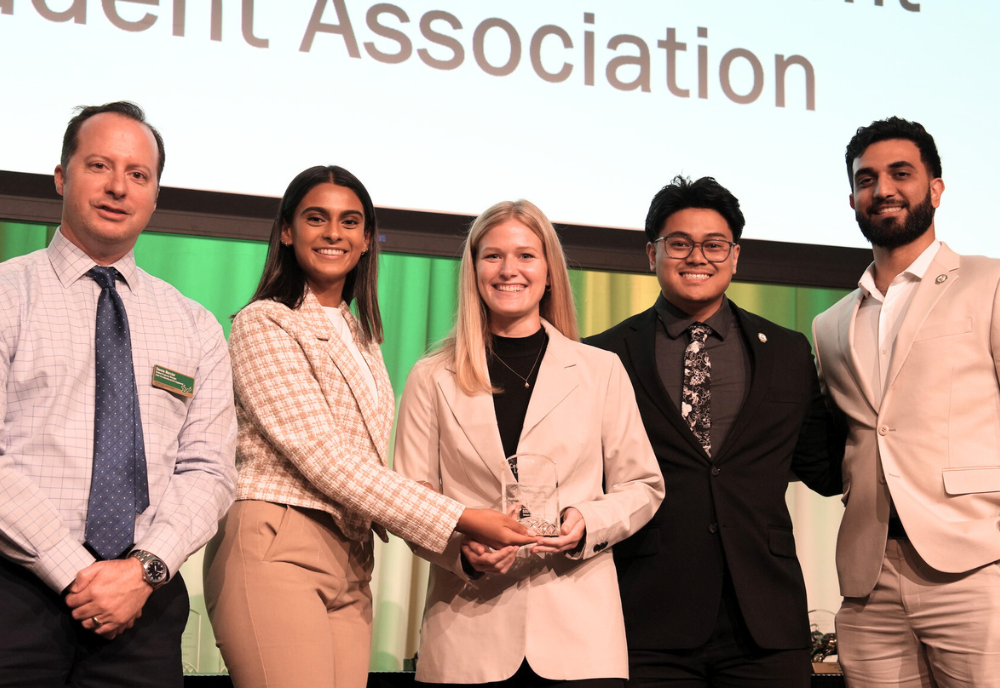 group of students holding an award