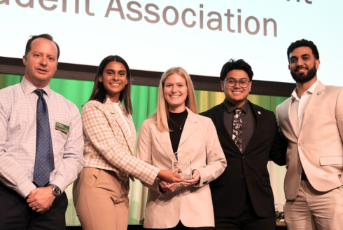 group of students holding an award